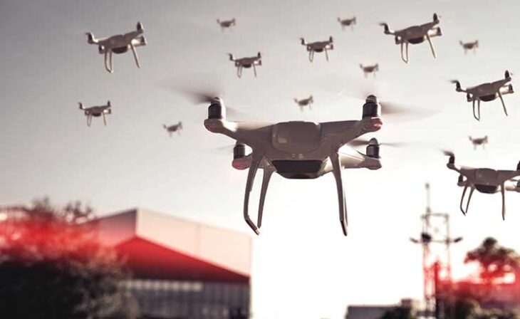 swarm-of-drones-surveying-flying-over-city-stockpack-adobe-stock-scaled