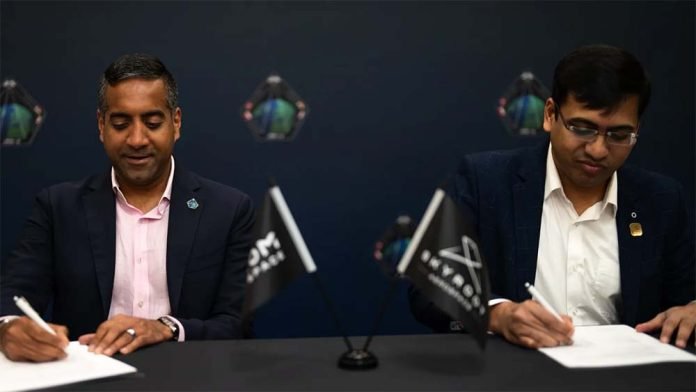 Tejpaul Bhatia, CEO of Axiom Space, and Pawan Kumar, CEO of Skyroot, sign