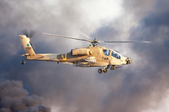 AH-64 Apache attack helicopter fly above Hatzerim Air Force base near Beersheba, Israel in front of black smoke